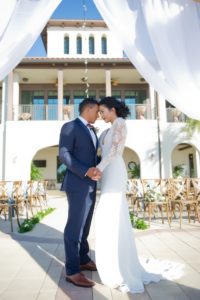 Outdoor Waterside Wedding Ceremony Portrait, Bride and Groom Under White Draped Ceremony Arch | Tampa Bay Waterfront Wedding Ceremony Venue Westshore Yacht Club | Tampa Bay Wedding Photographer Andi Diamond Photography