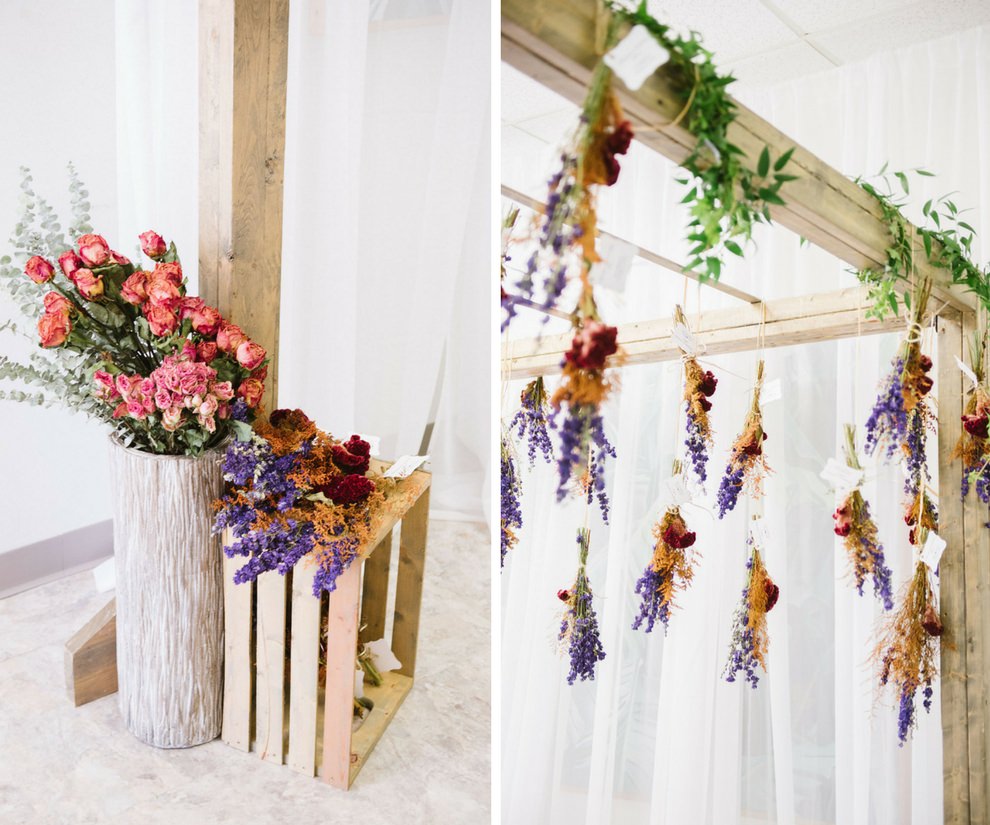 Jewel Tone Wedding Reception Decor with Purple, Gold, and Dark Red Hanging Dried Flower Bundles with Greenery, and Pink Rose Flower Arrangement with Rustic Bare Wood Stands | Clearwater Beach Wedding Planner Special Moments Event Planning