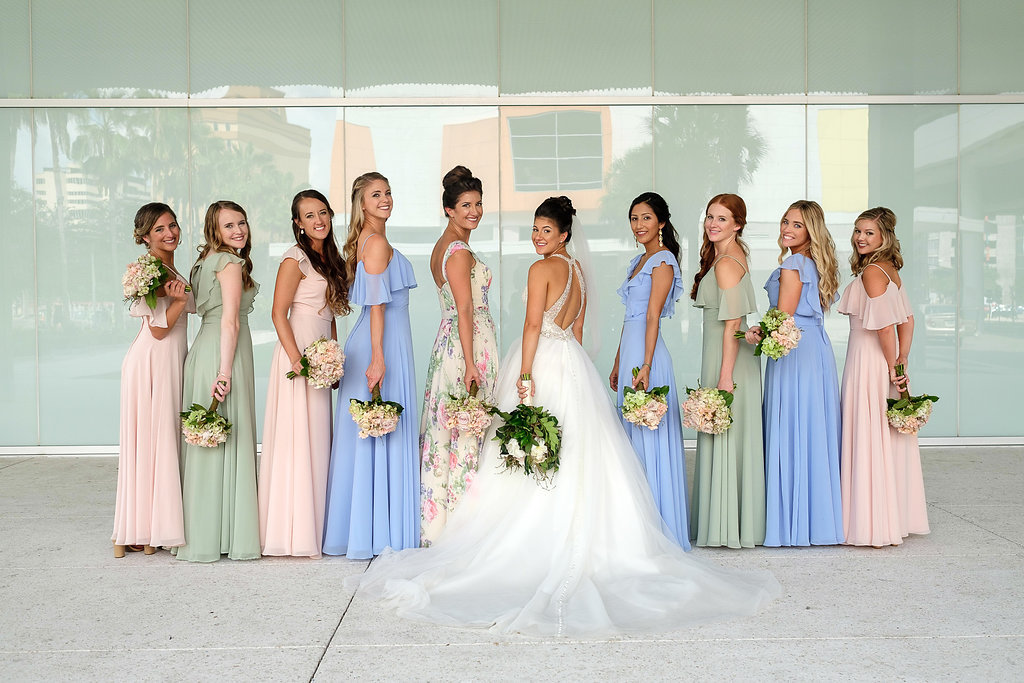 Outdoor Bridal Party Portrait, Bride in Cross Back Ballgown Madeline Gardner Wedding Dress with White Floral Bouquet with Greenery, Bridesmaids in Mismatched Morilee Bridal Dresses in Pink, Blue, and Sage Green, and Pink and Green Floral White Maid of Honor Dress | Tampa Wedding Photographer Marc Edwards Photographs