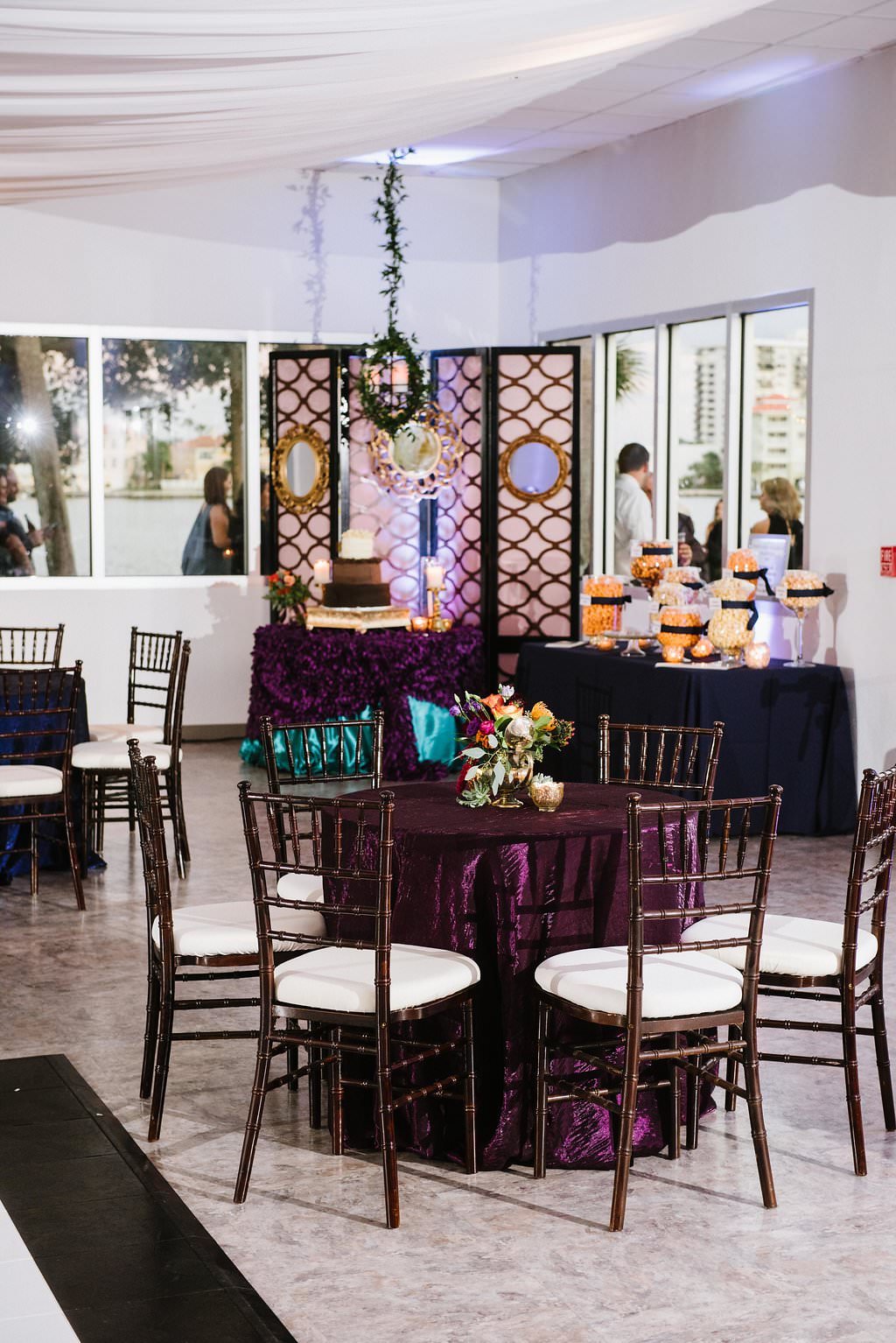 Whimsical Jewel Tone Wedding Reception with Amethyst Purple and Emerald Green Linens, and Brown Chiavari Chairs with White Cushions | Clearwater Wedding Venue Clearwater Beach Recreation Center | Tampa Bay Wedding Planner Special Moments Event Planning