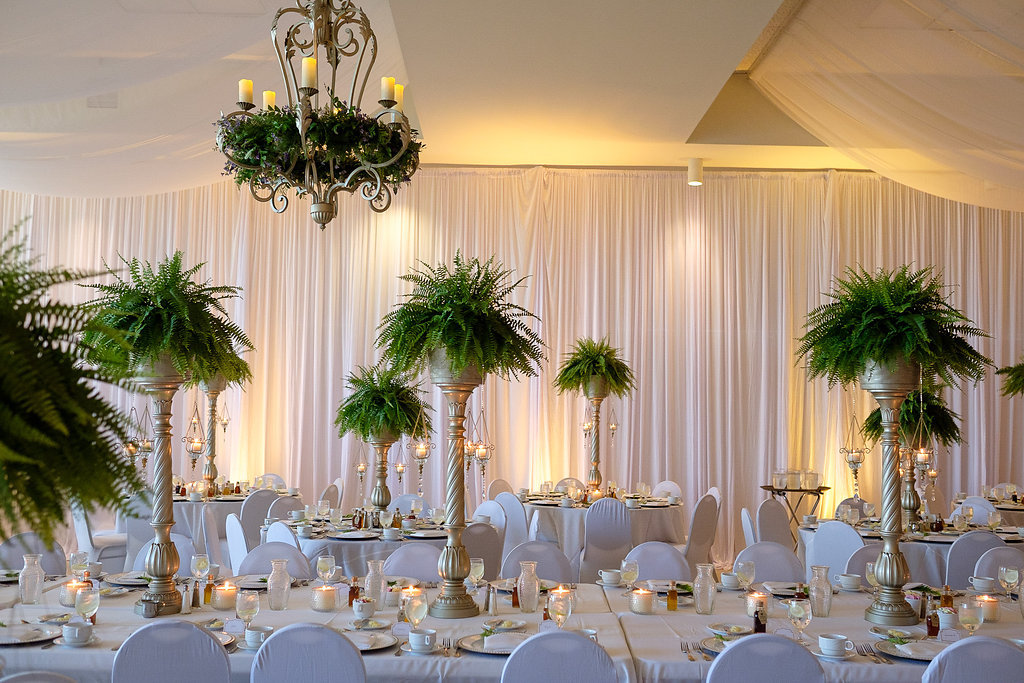 White and Greenery Wedding Reception with Feasting Table and Tall Fern Centerpieces in Gold Pillar Vases with White Draping | Wedding Rentals & Decor Gabro Event Services
