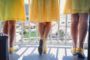 Bridesmaids in Mismatched Yellow Dresses and Matching Yellow Converse Sneakers Wedding Shoes | Purple and Yellow Disney Wedding at Hotel Wedding Venue Hilton Clearwater Beach