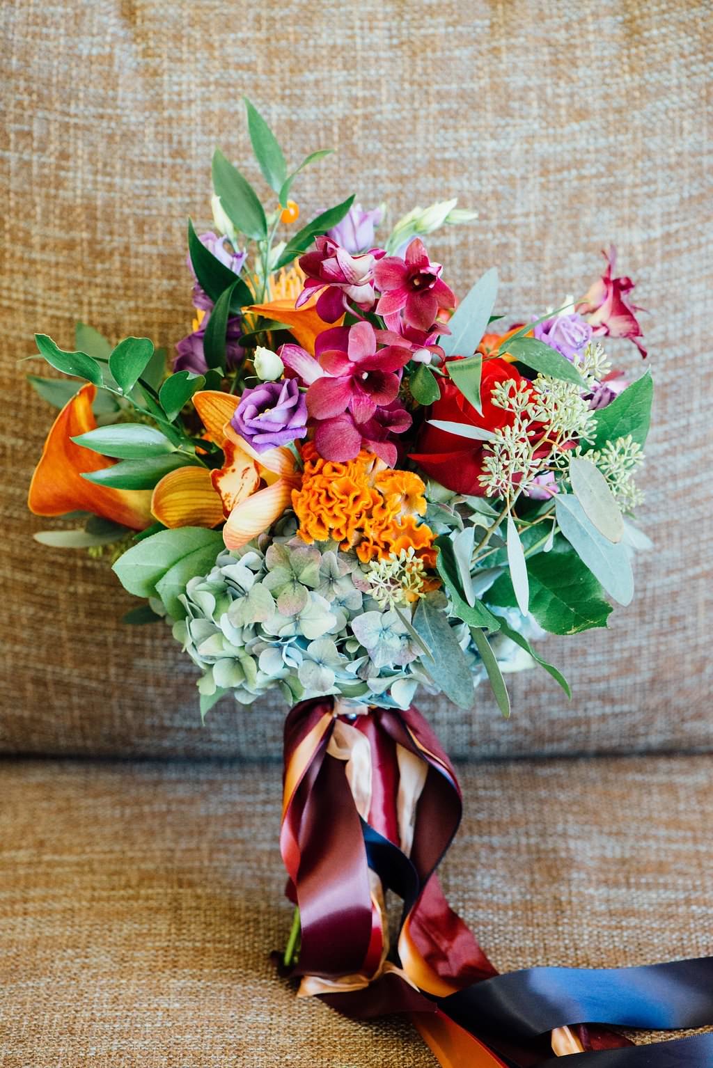 Orange, Red, Purple and Greenery Wedding Bouquet with Jewel Tone Ribbons