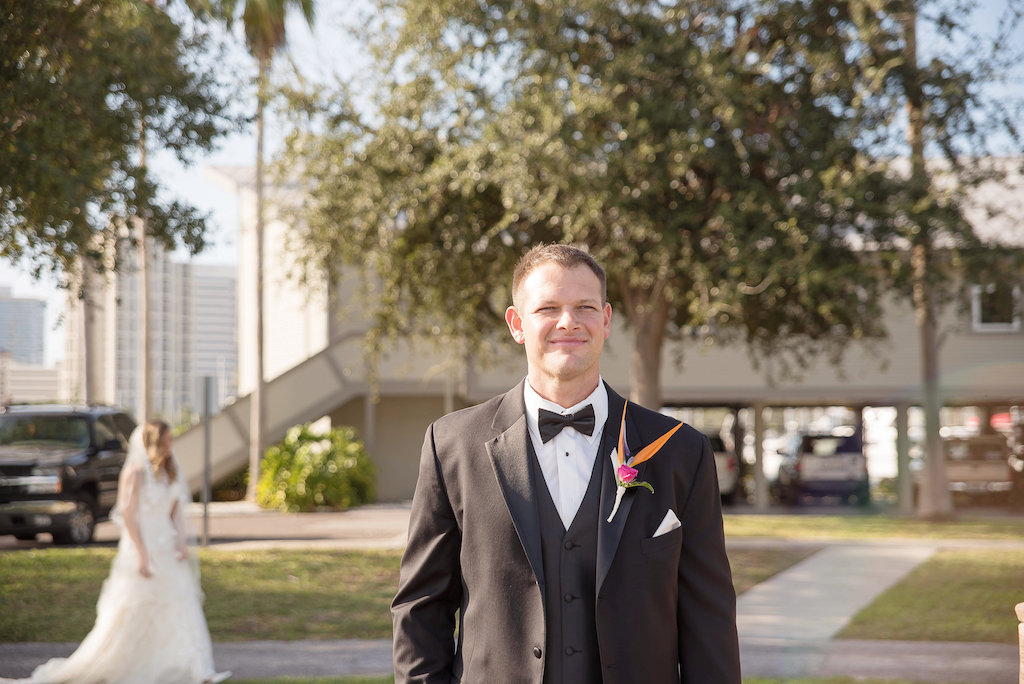 Outdoor First Look Portrait, Groom in Tuxedo with Bird of Paradise Flower Orange and Pink Tropical Boutonnière | St Pete Wedding Photographer Kristen Marie Photography