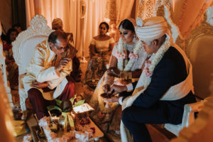 Regal and Romantic Traditional Hindu Indian Wedding Ceremony Bride and Groom Portrait with Gold Uplighting and Blush Pink Draping Behind the Mandap | Tampa Bay Wedding Venue Safety Harbor Resort and Spa | Planner Glitz Events | Photographer Grind and Press Photography