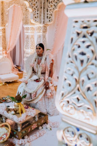 Regal and Romantic Traditional Hindu Indian Wedding Ceremony Bride Portrait with Gold Uplighting and Blush Pink Draping Behind the Mandap | Tampa Bay Wedding Venue Safety Harbor Resort and Spa | Planner Glitz Events | Photographer Grind and Press Photography