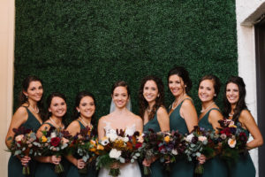 Outdoor Bridal Party Portrait, Bridesmaids in Matching V Neck Forrest Green Davids Bridal Dresses, with Yellow, Burgundy, Blush Rose and Floral Bouquet with Greenery | Tampa Bay Wedding Hair and Makeup Femme Akoi Studio | St Pete Boutique Hotel Wedding Venue The Birchwood