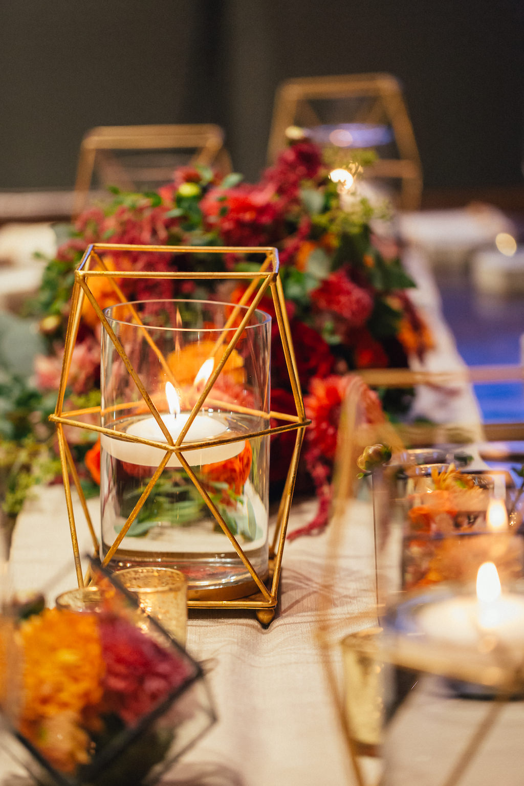 Intimate Wedding Reception Decor with Floating Votives in Brass Geometric Holders with Red Floral Centerpiece with Greenery | Tampa Wedding Planner UNIQUE Weddings and Events