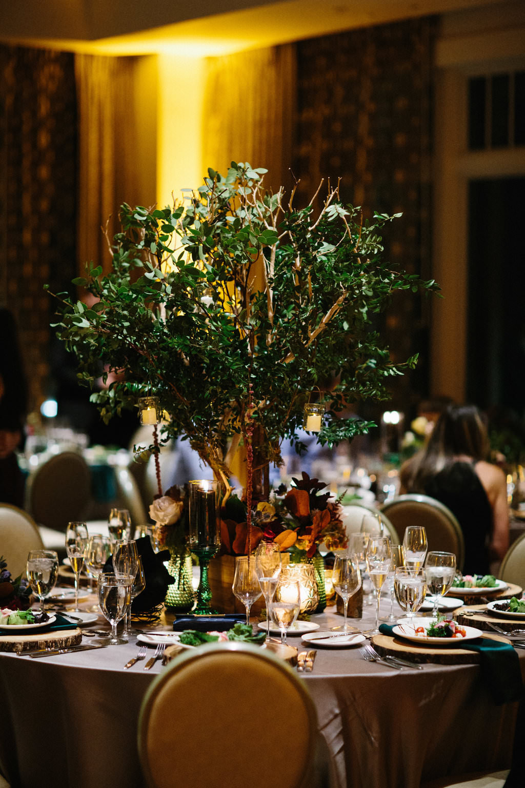 Nature Inspired Jewel Toned Wedding Reception with Tall Greenery and Branches Centerpiece with Purple, Red, and Yellow Florals, and Mauve and Emerald Linens | Downtown St Pete Boutique Hotel Wedding Venue The Birchwood
