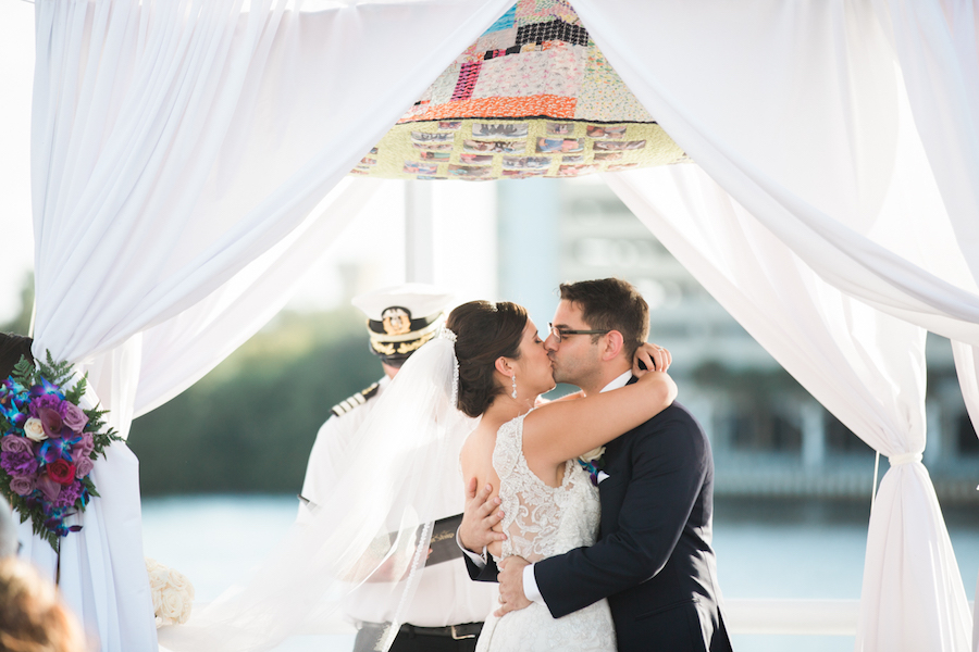 Outdoor On the Water Wedding Ceremony Portrait, White Draped Chuppah Wedding Arch with Purple, Blue, White, and Red Flower Arrangements | Tampa Bay Nautical Wedding Venue Yacht StarShip