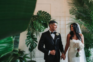 Modern Indian Wedding Bride and Groom Portrait, Bride in Strapless Wedding Dress, Groom in Black Tuxedo with White Rose Boutonniere and White Rose Bouquet | Tampa Wedding Photographer Grind and Press Photography