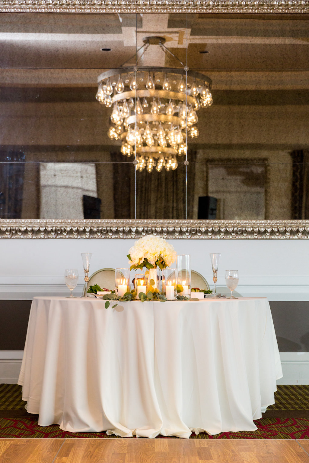 Vintage Hotel Ballroom Wedding Reception Sweetheart Table with White Peony with Greenery Centerpiece and Votive Candles | Tampa Bay Wedding Venue The Birchwood | Florist Cotton and Magnolia