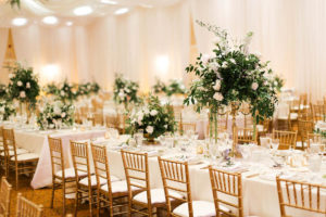 White and Greenery Ballroom Wedding Reception with Long Feasting Tables, Tall White Floral and Greenery Centerpiece in Gold Candelabra, with Gold Chiavari Chairs | White Ceiling Draping by Tampa Bay Gabro Event Services | Tarpon Springs Wedding Venue Inverness Hall at Innisbrook Resort