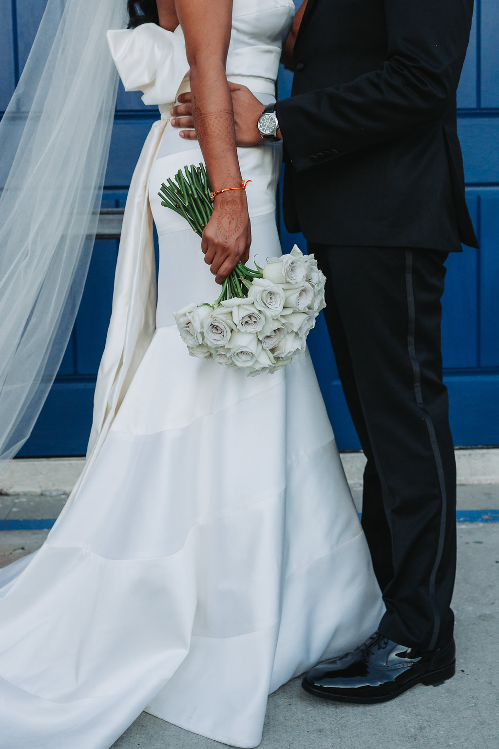 Modern Indian Wedding Bride and Groom Portrait, Bride in Strapless Wedding Dress, Groom in Black Tuxedo with White Rose Boutonniere and White Rose Bouquet | Tampa Wedding Photographer Grind and Press Photography