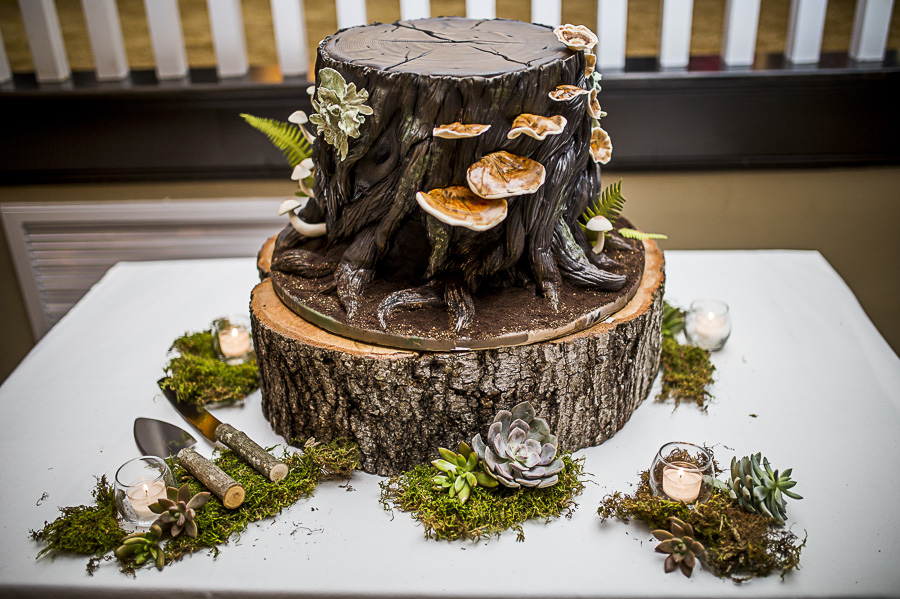 Creative Groom's Cake in the shape of a Tree Stump with Mushrooms and Lichen on Natural Edged Tree Round Cake Stand with Moss, Candles, and Succulents | St Pete Wedding Cake Bakery The Artistic Whisk