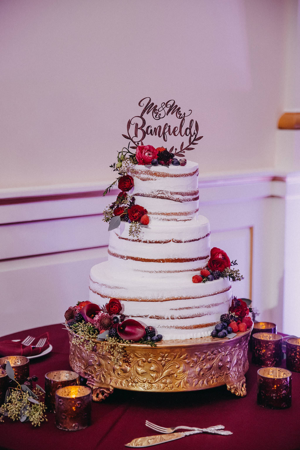 Three Tier Naked Frosting White Round WEdding Cake with Custom Cake Topper on Gold Cake Stand with Red Florals with Greenery and Blue Blueberries | Tampa Bay Cake and Caterer Olympia Catering