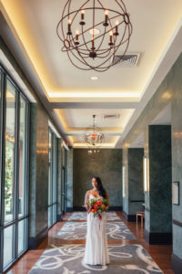 Hotel Interior Bridal Portrait in BHDLN Column Wedding Dress with Red, Orange and Greenery Bouquet | Tampa Boutique Hotel Wedding Venue The Epicurean