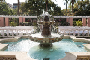 Outdoor Art Deco Historic Hotel Courtyard Wedding Ceremony with White Folding Chairs and Fountain | St Pete Wedding Venue The Vinoy