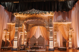 Regal and Romantic Traditional Hindu Indian Wedding Ceremony with Gold Uplighting and Blush Pink Draping Behind the Mandap | Tampa Bay Wedding Venue Safety Harbor Resort and Spa | Planner Glitz Events