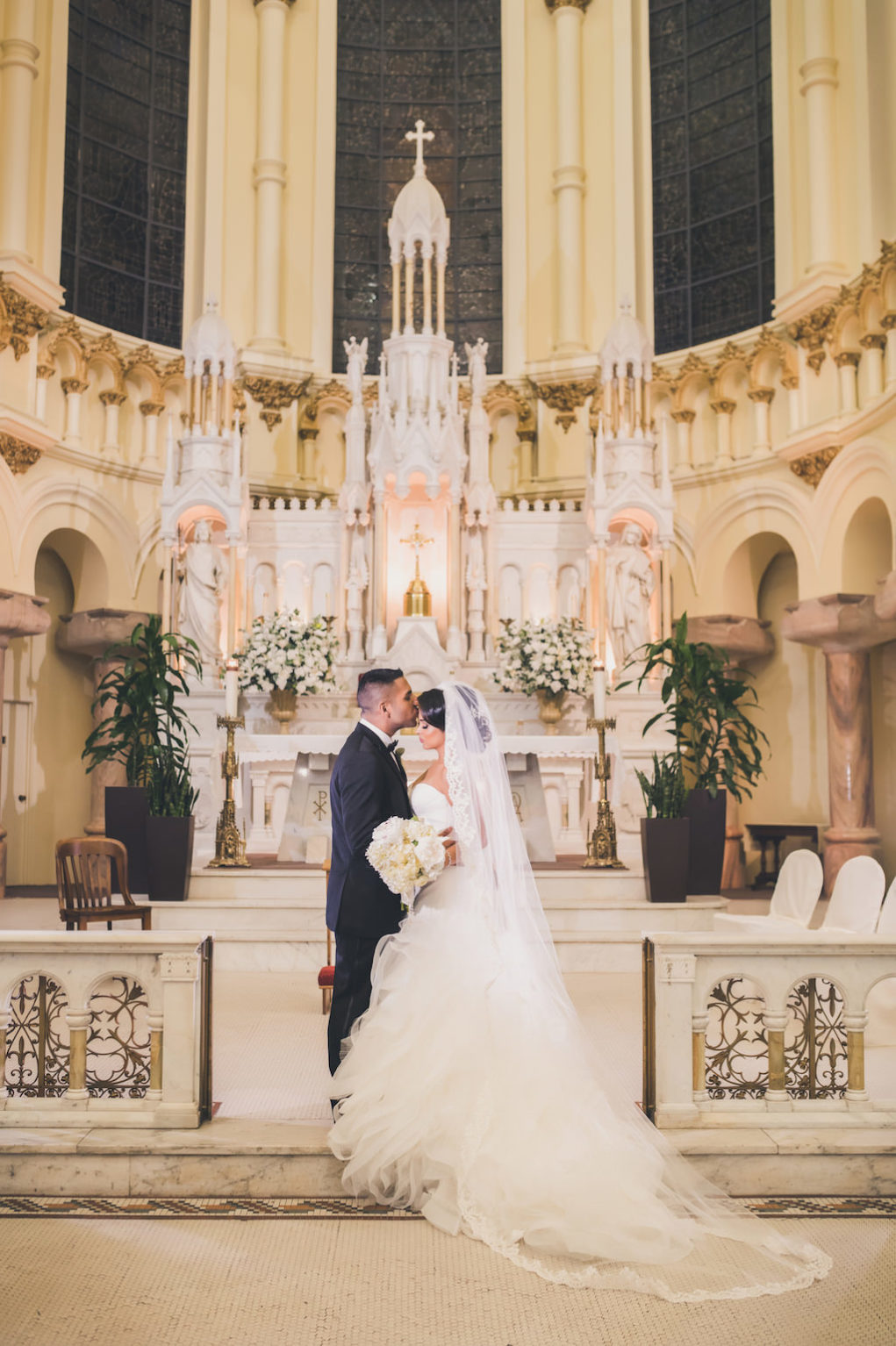 Traditional Church Wedding Ceremony, With White and Greenery Flower Arrangements Bride in Pronovias Layered Mermaid Strapless Dress | Downtown Tampa Wedding Ceremony Venue Sacred Heart Catholic Church | Planner Special Moments Event Planning