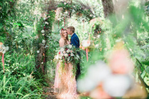 Outdoor Whimsical Garden Wedding Ceremony Inspiration with Rustic Arch and White and Deep Red Flowers