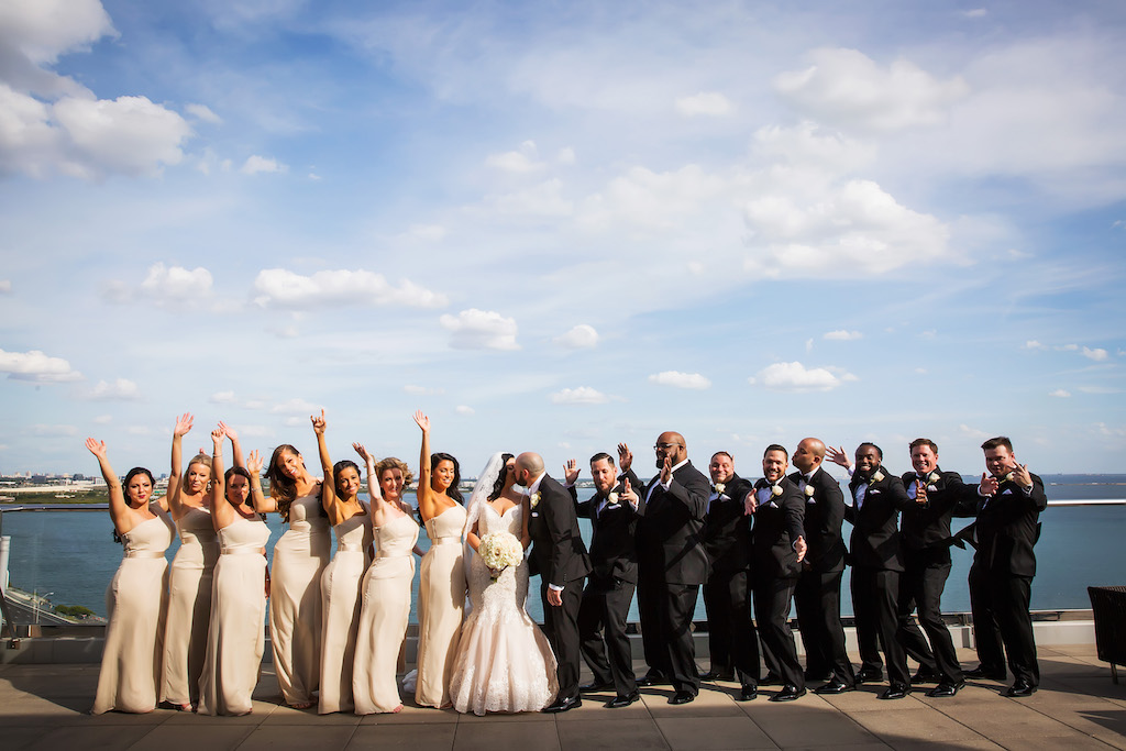 Rooftop Waterfront Wedding Party Portrait, Bridesmaids in Blush Vera Wang Strapless Belted Dresses, Groomsmen in Black Suits with White Rose Boutonniere | Hotel Wedding Ceremony Venue The Westin Tampa Bay