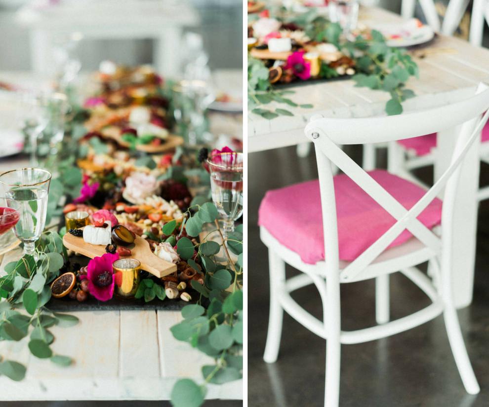 Modern Fuchsia Wedding Reception Table with Charcuterie Board with Greenery, Wooden Table, White Cross Back Chairs, Pink Linens | Lakeland Florida Wedding Caterer Tastes of Tampa Bay | Furniture and Dish Rentals A Chair Affair | Venue Haus 820