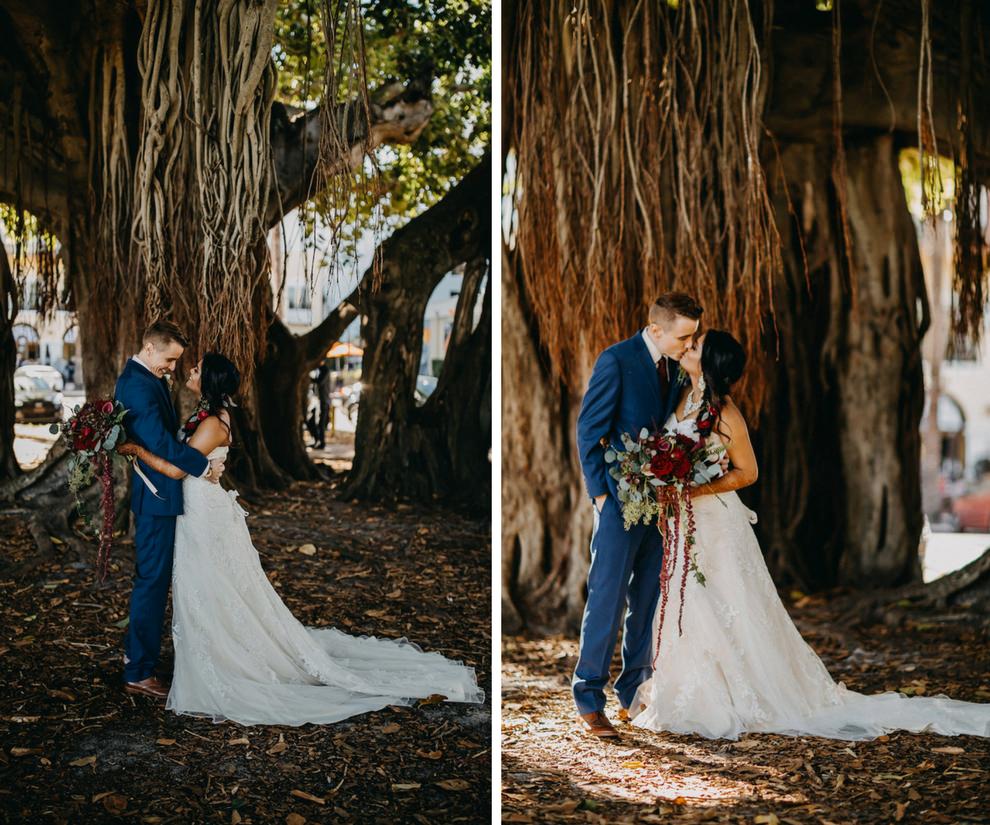 Blue and Red Modern Indian Wedding Outdoor First Look Portrait Under Banyan Tree, Bride in Lace Strapless Davids Bridal Dress, Groom in Navy Suit with Red Tie and Boutonniere, Red and Plum Floral with Greenery Bouquet | St Pete Wedding Photographer Rad Red Creative | Menswear Sacino's Formalwear