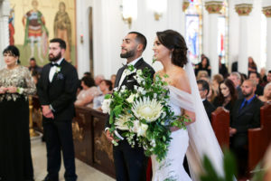 Greek Wedding Ceremony with Large Overside Wedding White and Green Wedding Bouquet | Tarpon Springs Traditional Wedding Venue St. Nicholas Greek Orthodox