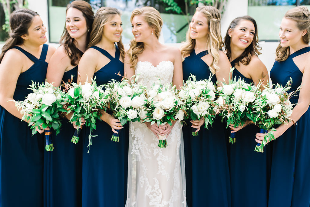 Outdoor Bridal Party Portrait in Navy Blue Cross Halter Lulus.com Dresses, Enzoani Sweetheart Lace wedding Dress, with White and Greenery Bouquets with Blue Ribbon