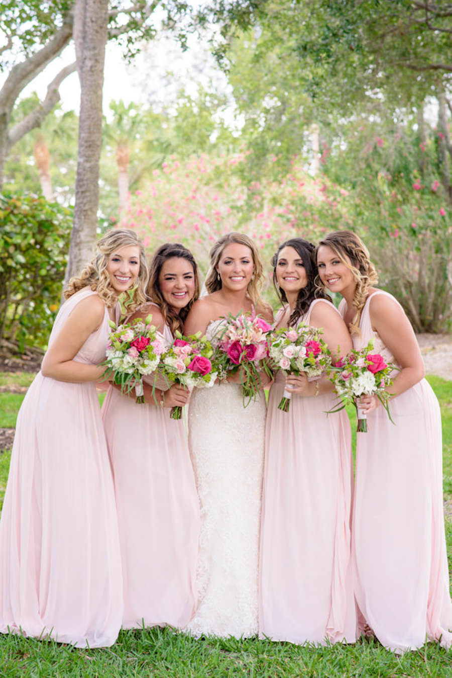 Outdoor Beach Wedding Bridal Party Ceremony Portrait, Bridesmaids in Pink Dessy Group Dresses, Bride in Lace Sweetheart Essense of Australia Dress, with Pink, Magenta, Yellow White Rose and Floral Bouquet with Tropical Greenery