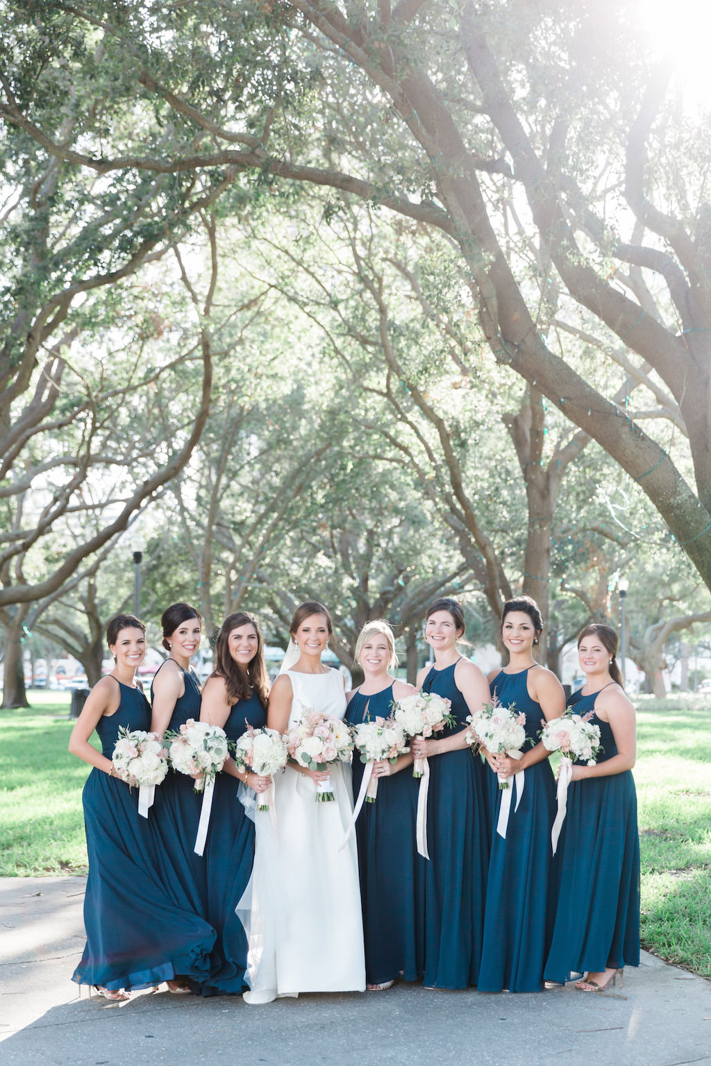 Outdoor Park Bridal Party Portrait, Bridesmaids in Floorlength Azazie Matching Halter Blue Dresses with White and BLush Pink Bouquets with Long RIbbon