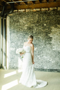 Industrial Indoor Bridal Portrait in Strapless Belted Robert Bullock Wedding Dress with White Floral Bouquet | Tampa Bay Wedding Photographer Ailyn La Torre Photography | Venue The Oxford Exchange