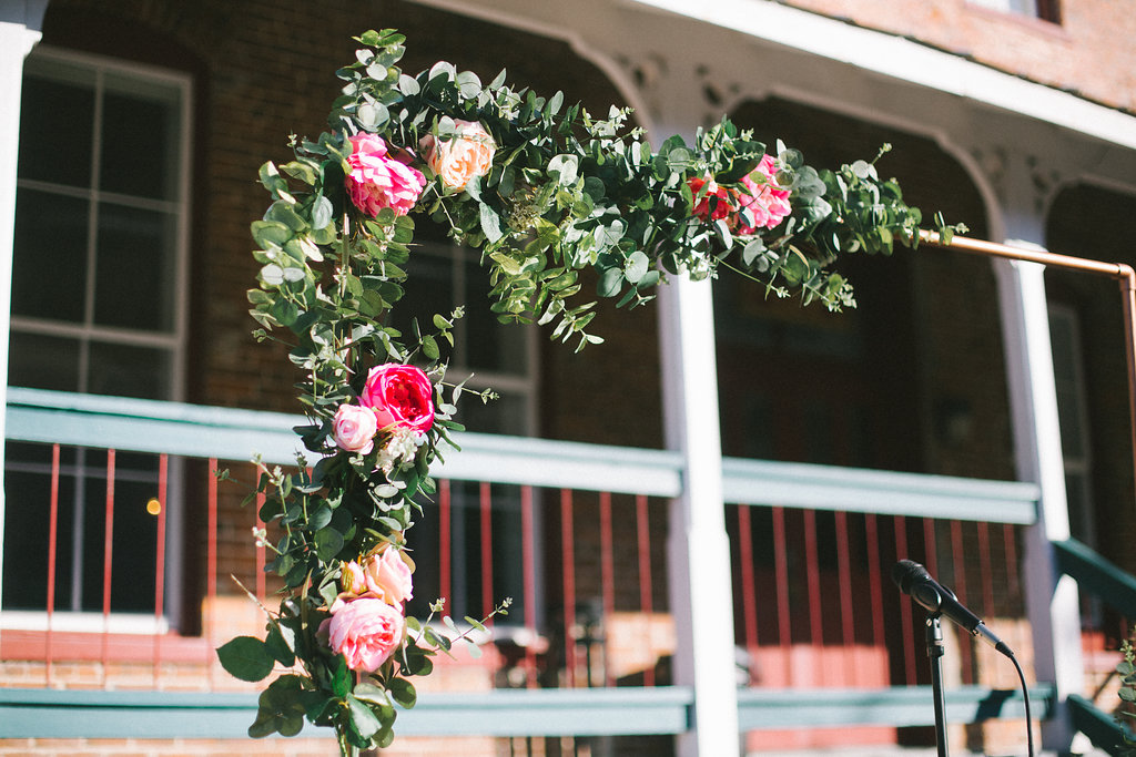 Outdoor Courtyard Wedding Ceremony Minimalist Arch with Pink and White Rose with Greenery Decor