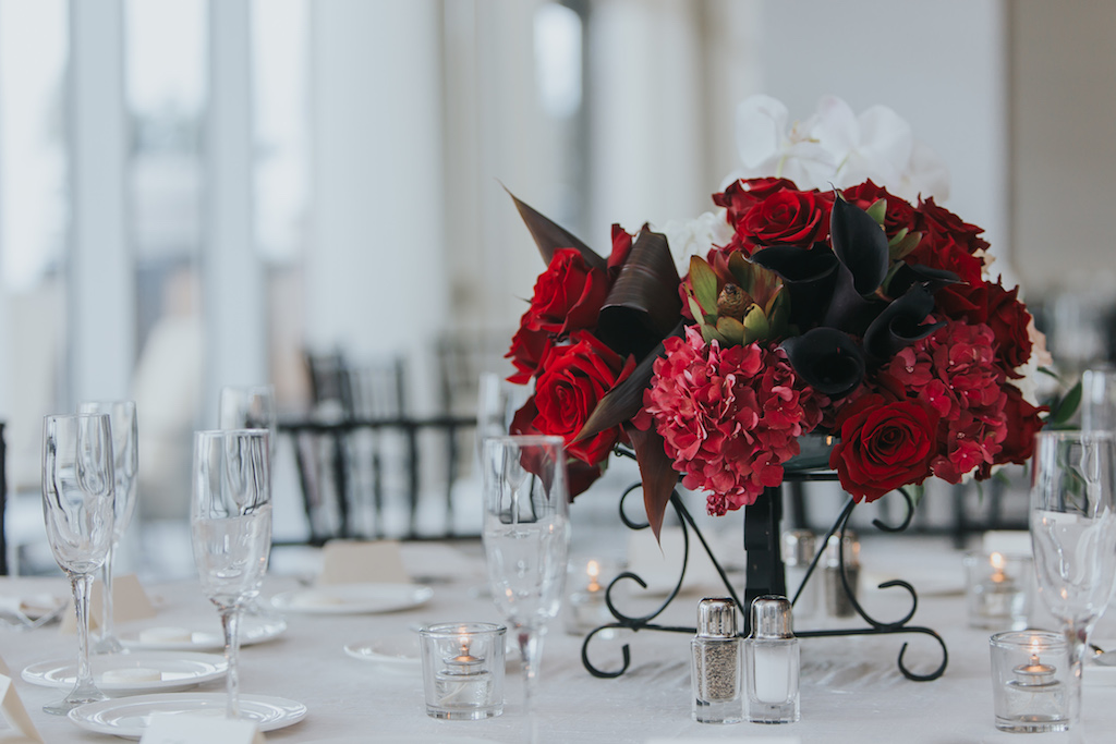 Modern, Red and White Wedding Reception Round Table Decor with Red ROse and WHite Floral with Greenery Low Centerpiece in Wrought Iron Vase, with Wood Chiavari Chairs | Tampa Bay Wedding Planner Special Moments Event Planning