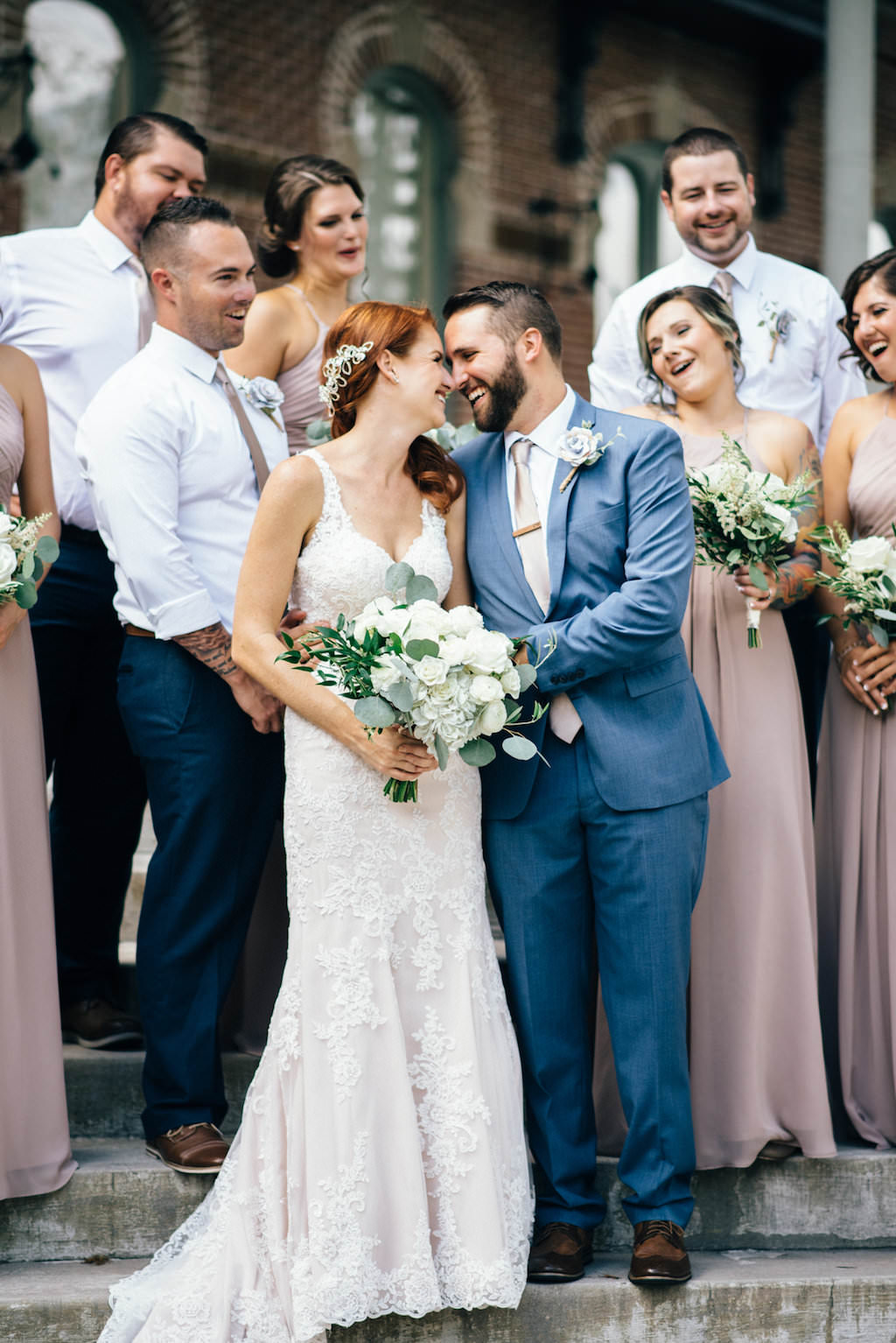 Downtown Tampa Outdoor Wedding Party Portrait with Historic Architecture, Bridesmaids in Taupe Floorlength Azazie Dresses, Groom in Blue Suit, Groomsmen in White Shirts with Taupe Ties