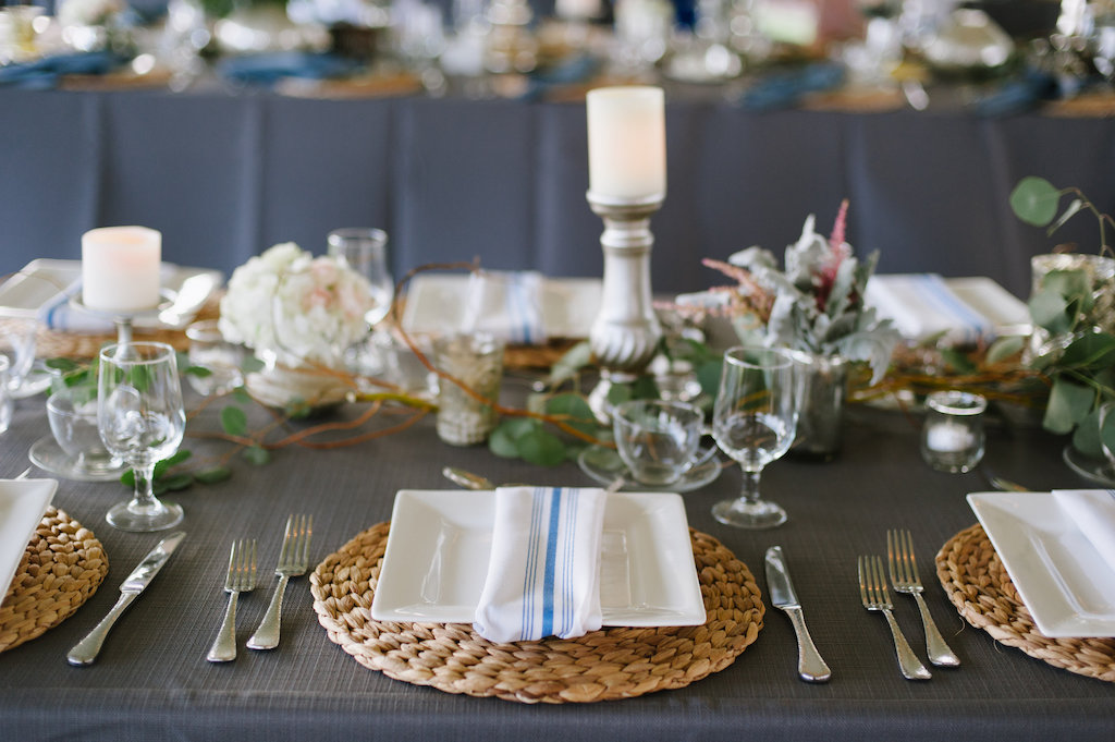 Outdoor Tented Wedding Reception with Organic Greenery Inspired Decor, Long Feasting Tables, Wicker Placemat Chargers and Candle Centerpieces | Sarasota Wedding Planner Jennifer Matteo Event Planning