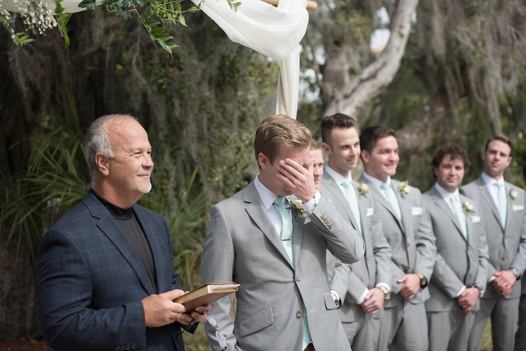 Outdoor Garden Wedding Ceremony Groom Portrait, Groomsmen in Gray Suits with Mint Green Tie and White Floral Boutonniere | Sarasota Wedding Photographer Kristen Marie Photography