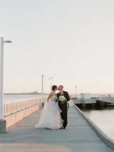 Outdoor Waterfront Wedding Portrait, Bride in Layered Strapless Ballgown Dress with White Rose and Greenery Bouquet | Tampa Wedding Venue The Westshore Yacht Club | Planner UNIQUE Weddings and Events