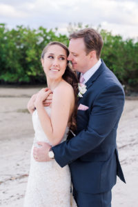 Beach Wedding Portrait, Bride in Lace Stella York Dress, Groom in Navy Blue Suit with Pink Tie and White Rose Boutonniere | Waterfront Hotel Wedding Venue The Westin Tampa Bay