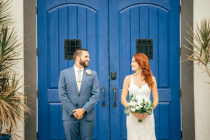 Downtown Tampa Creative Wedding Portrait, Bride in Sweetheart Lace Stella York Dress with White and Greenery Bouquet, Groom in Blue Suit with Taupe Tie and Paper Rose Boutonniere | Wedding Planner Glitz Events | Industrial Venue The Rialto
