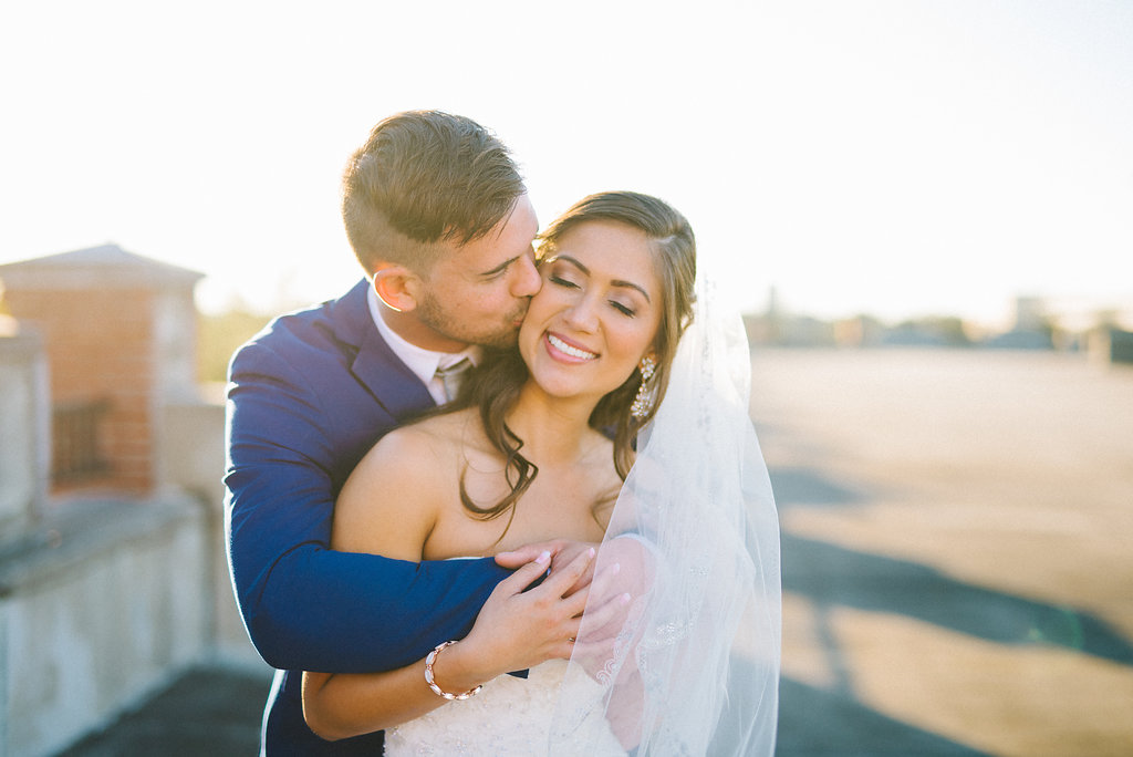 Industrial Chic Rooftop Wedding Portrait, Bride in Mermaid Enzoani Dress, Groom in Blue Suit with Brown Shoes | Tampa Wedding Photographer Kera Photography