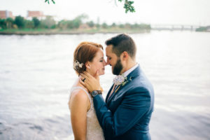 Downtown Tampa Waterfront Bride and Groom Portrait, Groom in BLue Suit with White Paper Rose Boutonniere