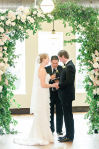 Indoor Industrial Garden Wedding Ceremony Portrait, with Greenery and White Floral Arch | Tampa Bay Wedding Photographer Ailyn La Torre | Venue The Oxford Exchange