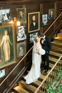 Indoor Staircase Bride and Groom Portrait with Vintage Portraits | Tampa Bay Wedding Photographer Ailyn La Torre Photography | Venue The Oxford Exchange