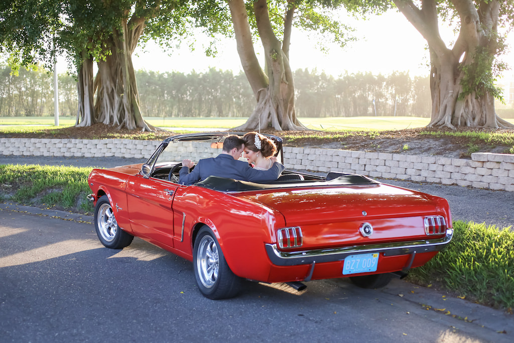 Bride and Groom Portrait in Red Vintage Mustang Classic Convertible Car | Tampa Bay Wedding Planner Kelly Kennedy Weddings and Events | Photographer Lifelong Photography Studios