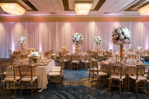 Whimsical Gold and Pink Hotel Ballroom Wedding Reception with Tall White Hydrangea Pink Rose and Greenery Centerpieces in Gold Vases, Gold Sequin Table Cloths, and Gold Chiavari Chairs | Tampa Bay Wedding Draping, Linen, and Furniture Rental Gabro Event Services | Venue Hilton Clearwater Beach