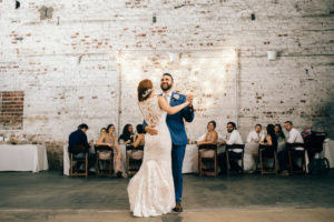 Vintage Inspired Wedding Reception First Dance Portrait, Groom in Blue Suit, Bride in Illusion Lace Back Stella York Dress | Historic Downtown Tampa Wedding Venue The Rialto Theatre | Planner Glitz Events