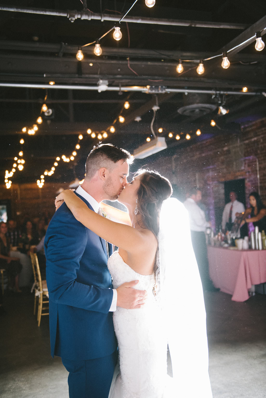 Industrial Chic Wedding Reception Bride and Groom First Dance Portrait with String Lights | Downtown Tampa Ybor City Historic Venue CL Space