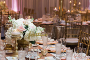 Whimsical Gold and Pink Hotel Ballroom Wedding Reception with Low White Hydrangea Pink Rose and Greenery Centerpieces in Gold Vases, Gold Sequin Table Cloths, and Gold Chiavari Chairs and Stylish Gold Candlestick Holders and Table Numbers | Tampa Bay Wedding Draping, Linen, and Furniture Rental Gabro Event Services | Venue Hilton Clearwater Beach